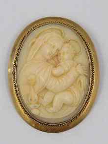 Appraisal: A finely carved ivory cameo depicting mother and child in