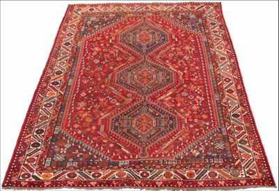 Appraisal: A Shiraz Carpet Medium sized carpet with cranberry and blue