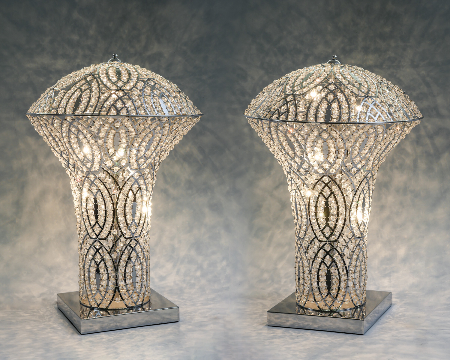 Appraisal: PAIR OF BEADED BETHEL INTERNATIONAL TABLE LAMPS Chromed frame with