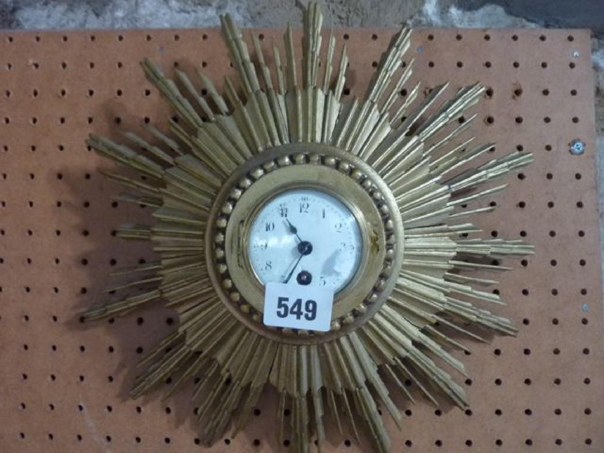 Appraisal: A miniature Star burst wall clock carved and gilded case