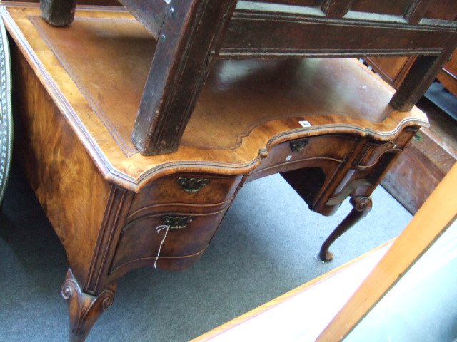 Appraisal: A th century walnut serpentine fronted writing desk the tooled