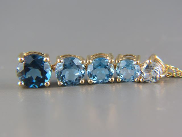 Appraisal: Blue Topaz Pendant round gems from light blue to deep