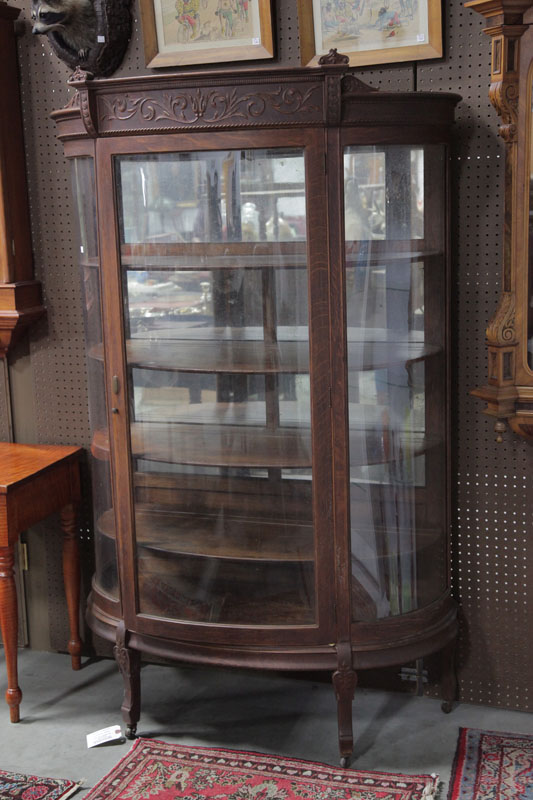 Appraisal: CHINA CABINET Oak having a foliate carved crest curved glass