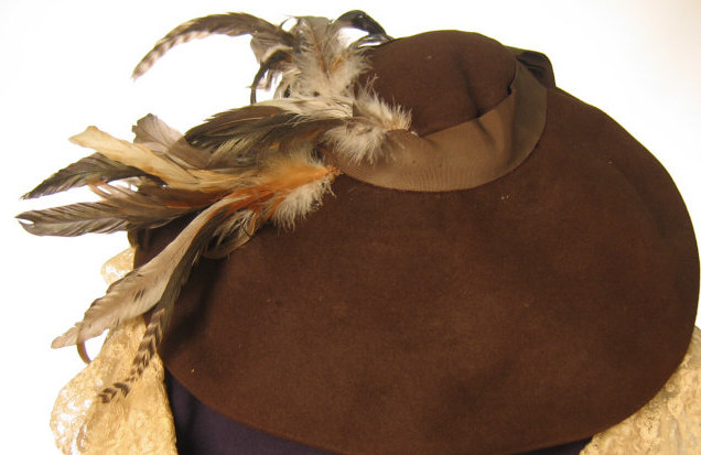 Appraisal: MC QUIRE BROWN HAT WITH FEATHERS Designed by Beverly Devon