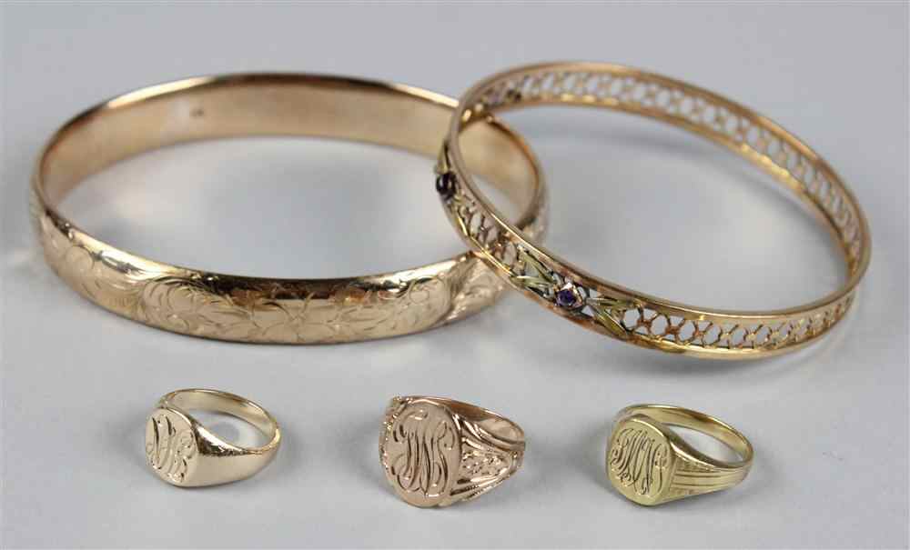 Appraisal: THREE SMALL GOLD SIGNET RINGS AND TWO BANGLE BRACELETS the