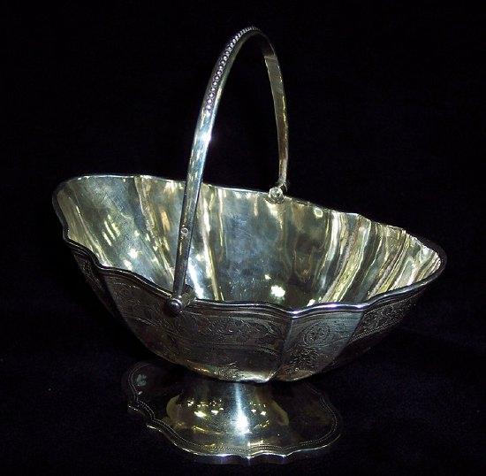 Appraisal: A Victorian oval sugar basket chased and engraved flowers and