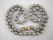 Appraisal: A grey South Sea cultured pearl necklace with a yellow