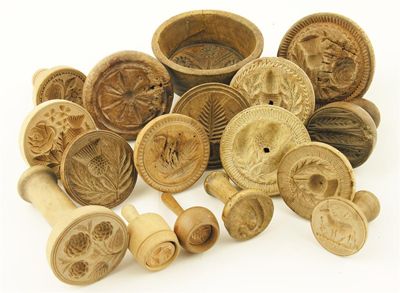 Appraisal: Sycamore butter stamps turned with handles and carved decoration including