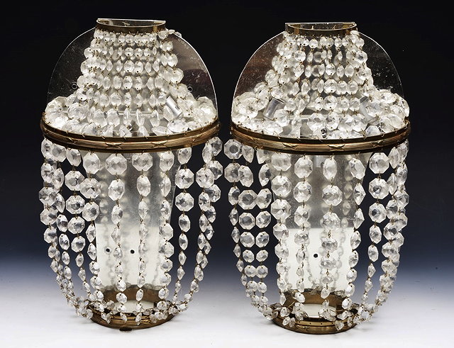 Appraisal: A PAIR OF BOW FRONTED FACET CUT LUSTRE WALL LIGHTS