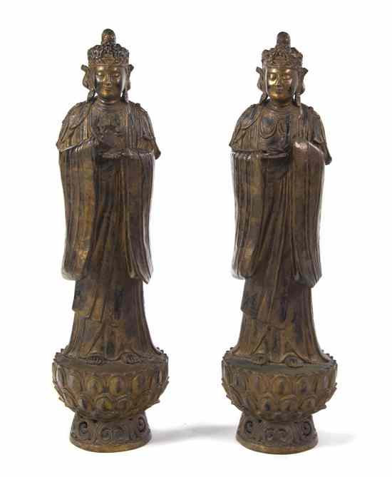 Appraisal: A Pair of Chinese Bronze Figures each depicted with a