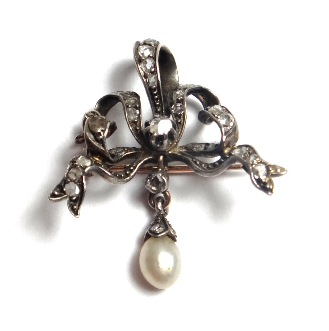 Appraisal: A diamond and cultured pearl set brooch designed as a