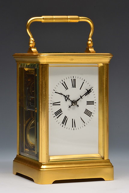 Appraisal: A French carriage clockwith white enamel Roman dial silvered platform