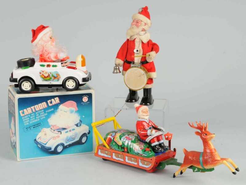 Appraisal: Lot of Battery-Operated Santa Toys Description Includes one Cartoon Car