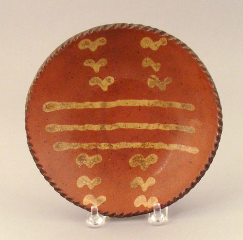 Appraisal: Redware pie plate th c with yellow slip decoration dia