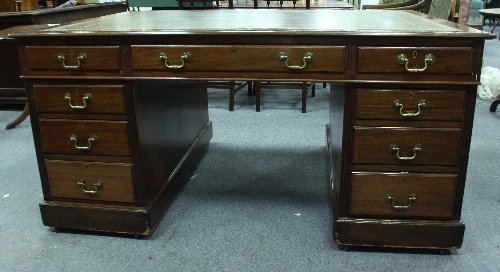 Appraisal: An Edwardian mahogany partners' desk with leather inset top above