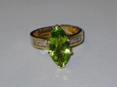 Appraisal: A PERIDOT AND DIAMOND DRESS RING the marquise cut peridot