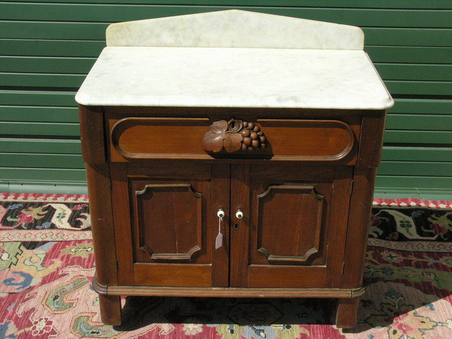 Appraisal: VICTORIAN WALNUT MARBLE TOP WASHSTAND One Drawer two door Size