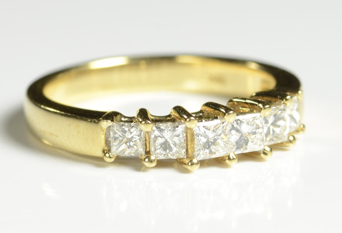 Appraisal: DIAMOND AND EIGHTEEN KARAT GOLD RING set with six princess-cut