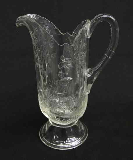 Appraisal: Early pressed glass pitcher with lady cyclist '' Ht Dalzell