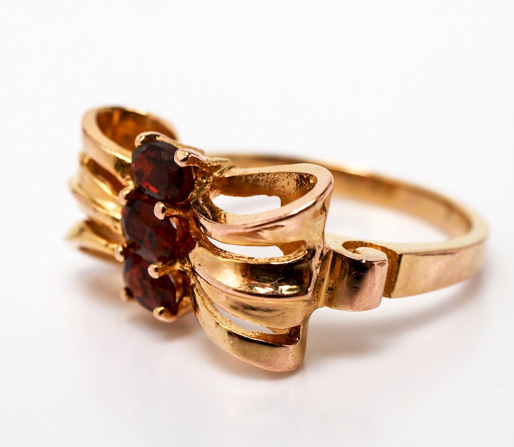 Appraisal: K Yellow Gold Ribbon Motif Ring with Garnets K yellow