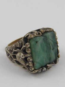 Appraisal: A white and yellow metal ring set with carved jadeite