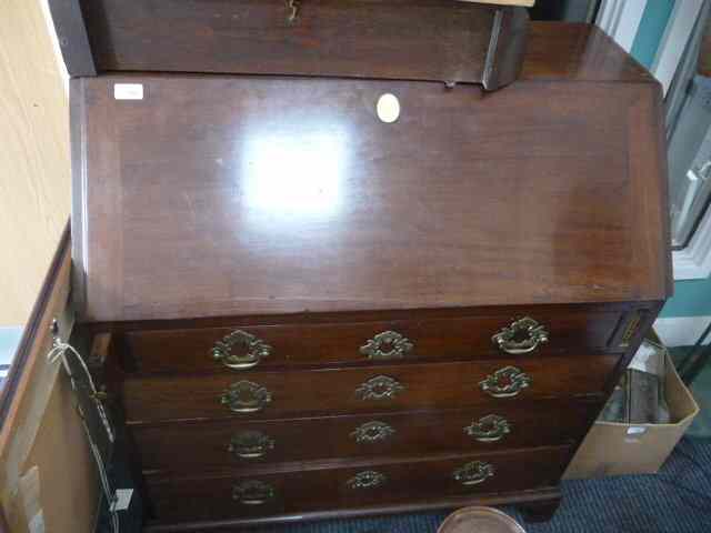 Appraisal: A GEORGIAN MAHOGANY BUREAU the fall front enclosing a fitted