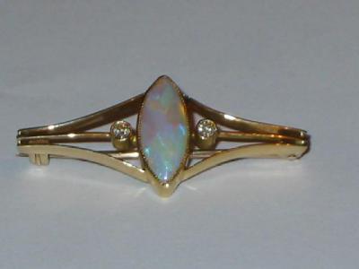 Appraisal: AN OPAL AND DIAMOND BROOCH the central marquise opal cabochon