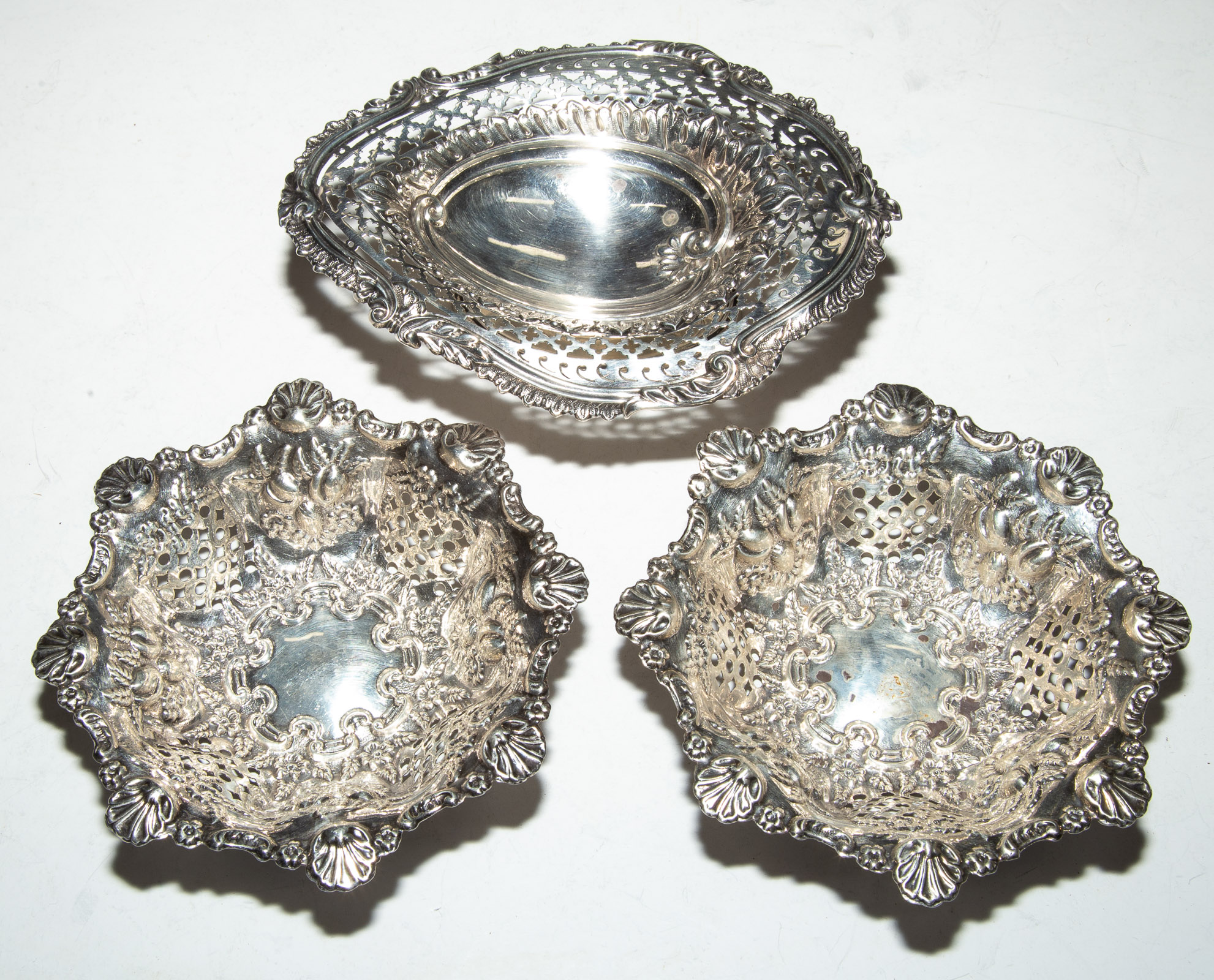 Appraisal: THREE SMALL ENGLISH STERLING BASKETS Including a pair of Edward