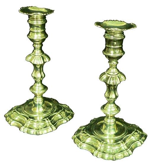 Appraisal: A pair of George II cast table candlesticks with banded