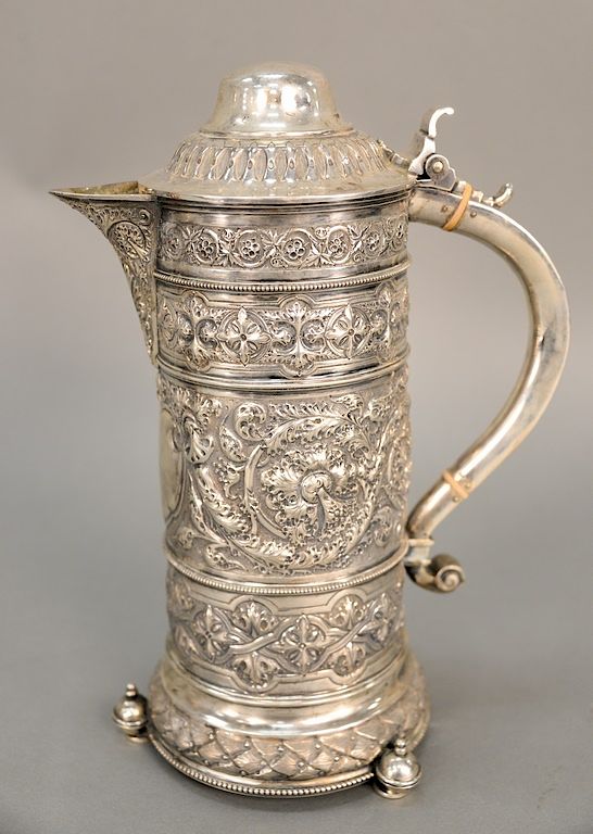 Appraisal: English silver ewer having overall embossed body on three round