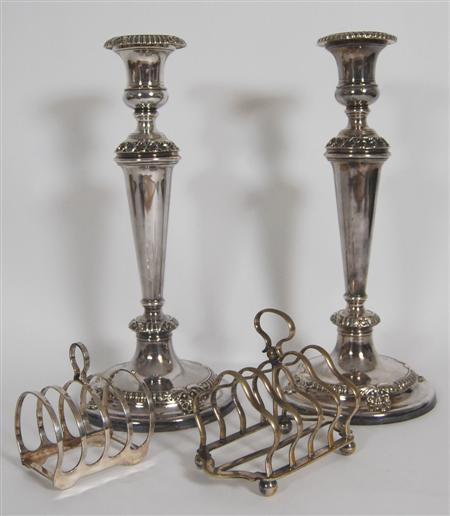 Appraisal: A pair of silver plated candlesticks the tapered stem with