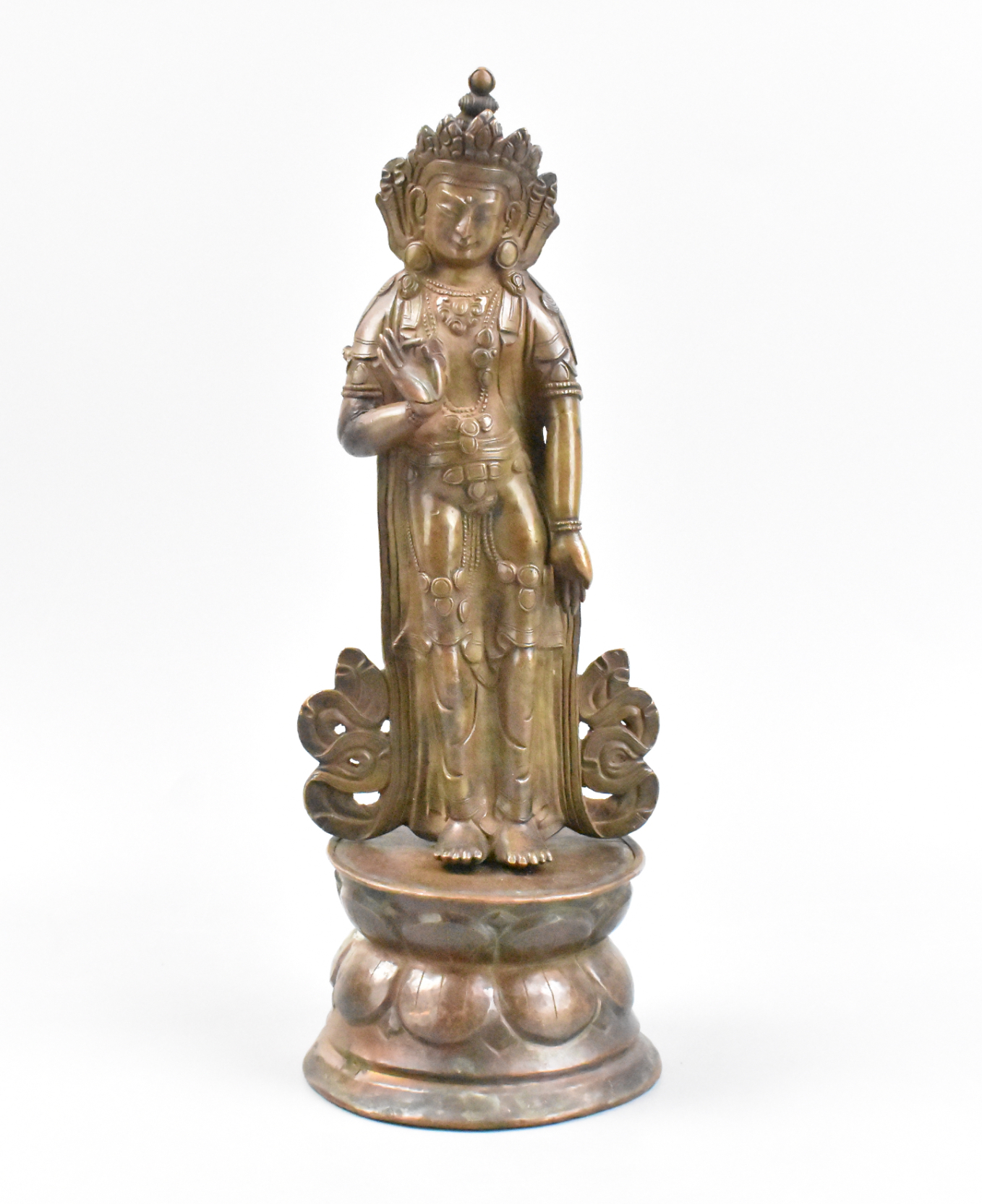 Appraisal: A standing Tara Buddha above a lotus base He holds