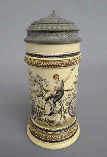 Appraisal: German stein with painted man on highwheel Pewter lid has