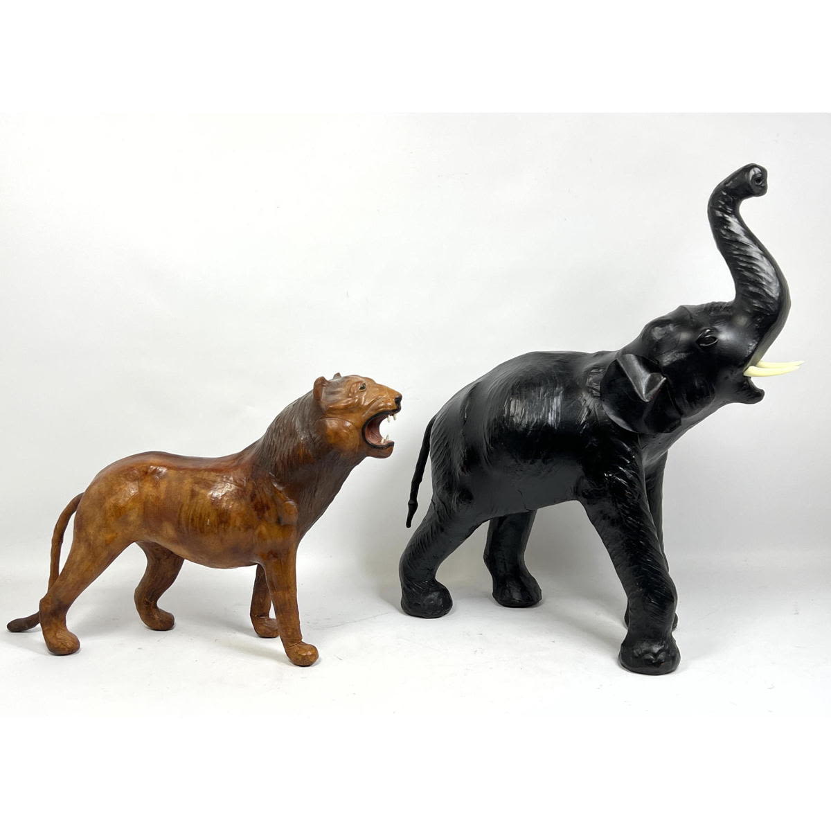 Appraisal: pc Hand Painted Leather Animal Figures Lioness Elephant Dimensions H