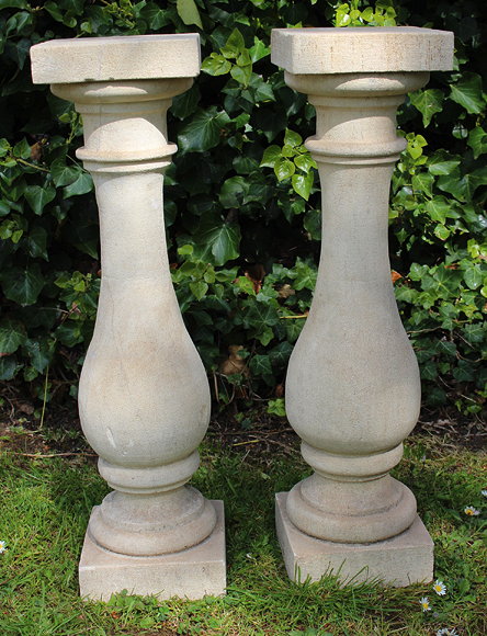 Appraisal: A PAIR OF TURNED LIMESTONE BALUSTERS with tops and bases