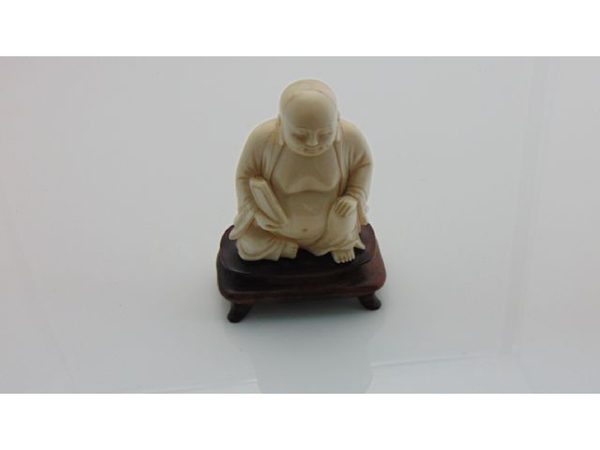 Appraisal: A th century carved ivory figure of the seated buddha