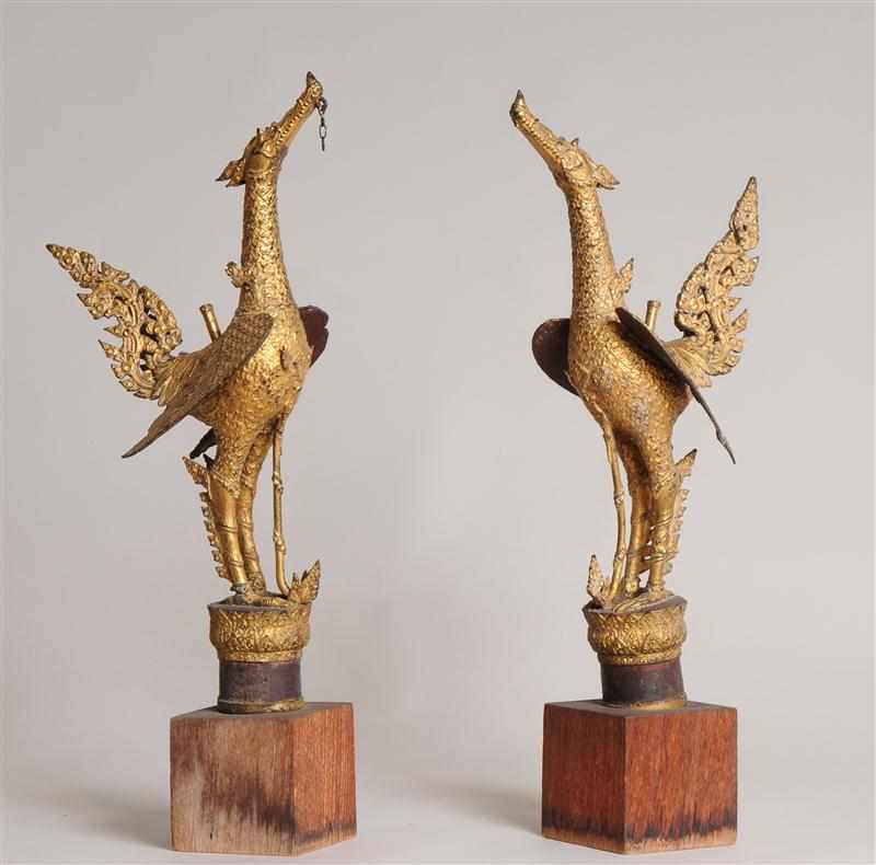 Appraisal: PAIR OF THAI GILT-METAL BIRD FINIALS Each with raised wings