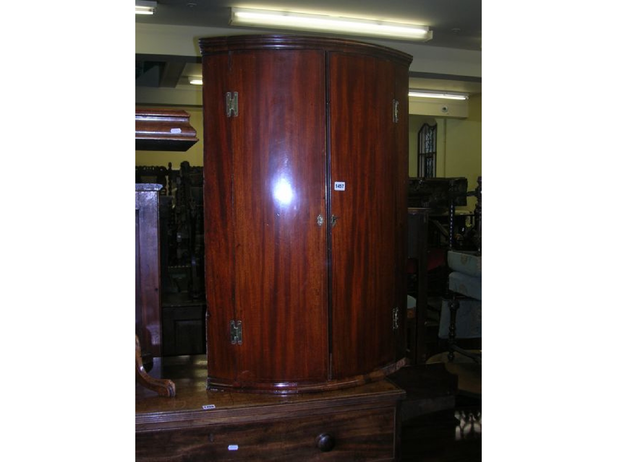 Appraisal: A Georgian mahogany wall mounted hanging corner cupboard with bow