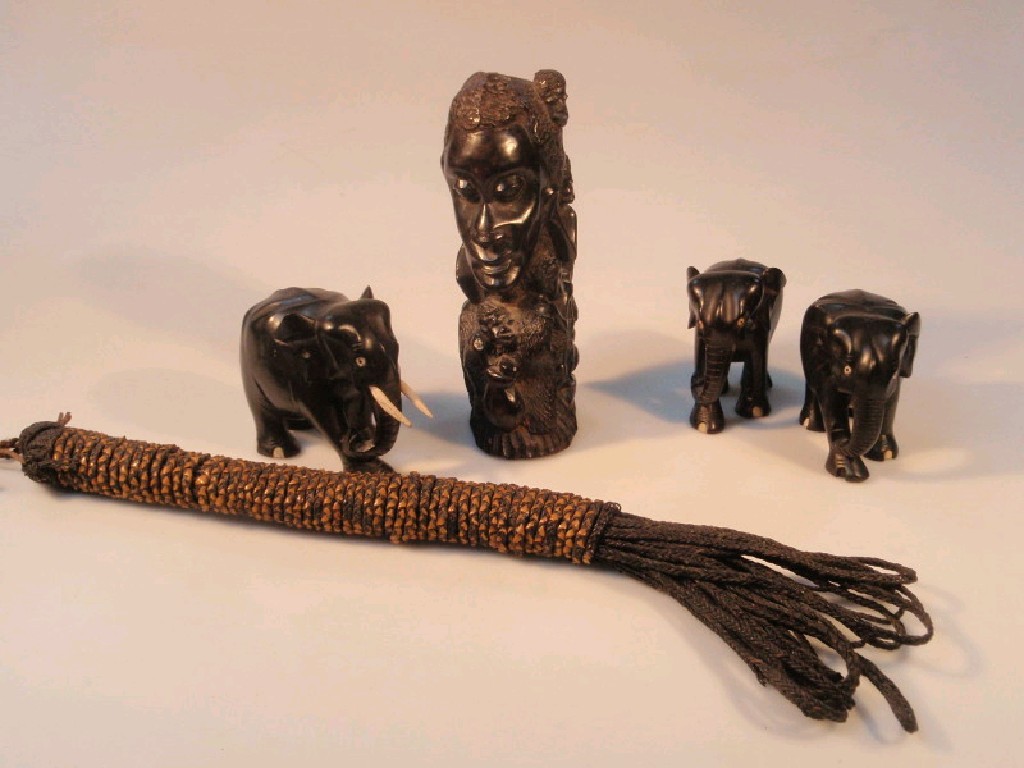 Appraisal: Three small carved ebony elephants tribal carved figure and a