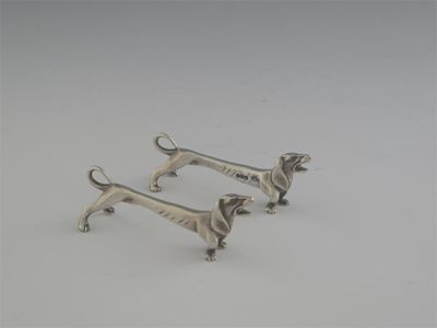 Appraisal: A pair of Edwardian cast novelty knife rests in the