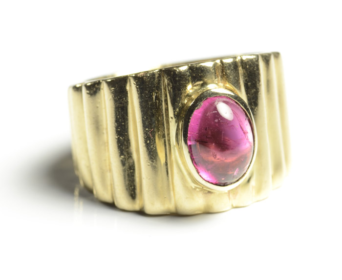 Appraisal: PINK TOURMALINE AND FOURTEEN KARAT GOLD RING The wide yellow