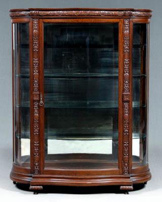 Appraisal: Carved oak curved glass vitrine curved glass central door opening