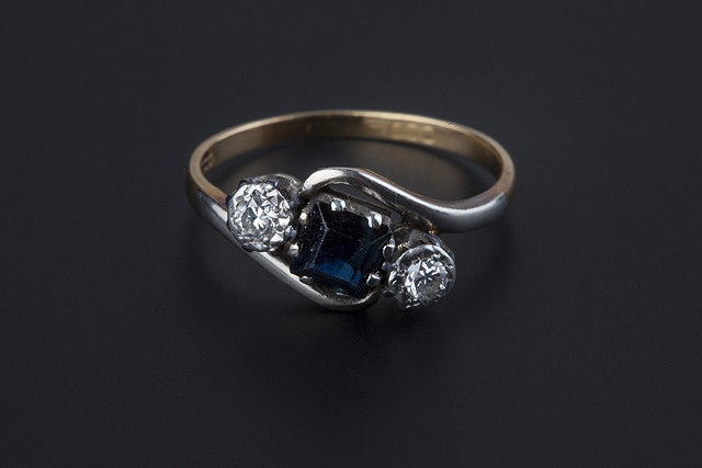 Appraisal: A sapphire and diamond three stone ring of crossover design