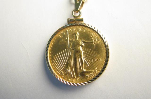 Appraisal: A ounce gold Liberty coin in K yellow gold bezel