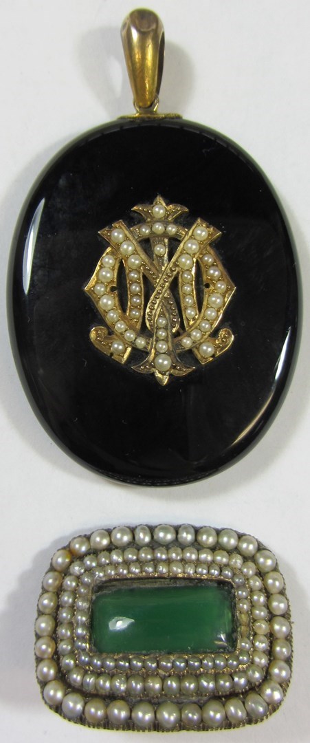 Appraisal: A Victorian black onyx oval pendant locket the front mounted