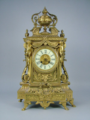 Appraisal: A late th century gilt brass cased mantel clock decorated