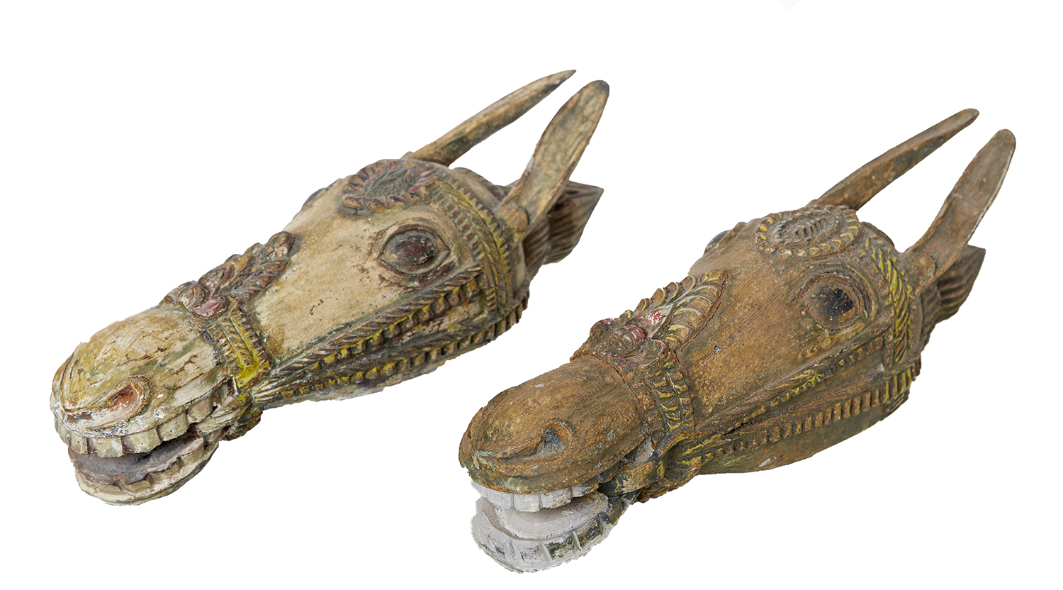 Appraisal: A PAIR OF INDIAN CARVED HORSES HEADS LATE TH EARLY