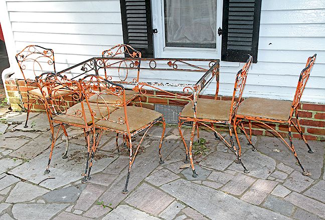 Appraisal: Salmon Iron Patio Set A ca table with chairs glass