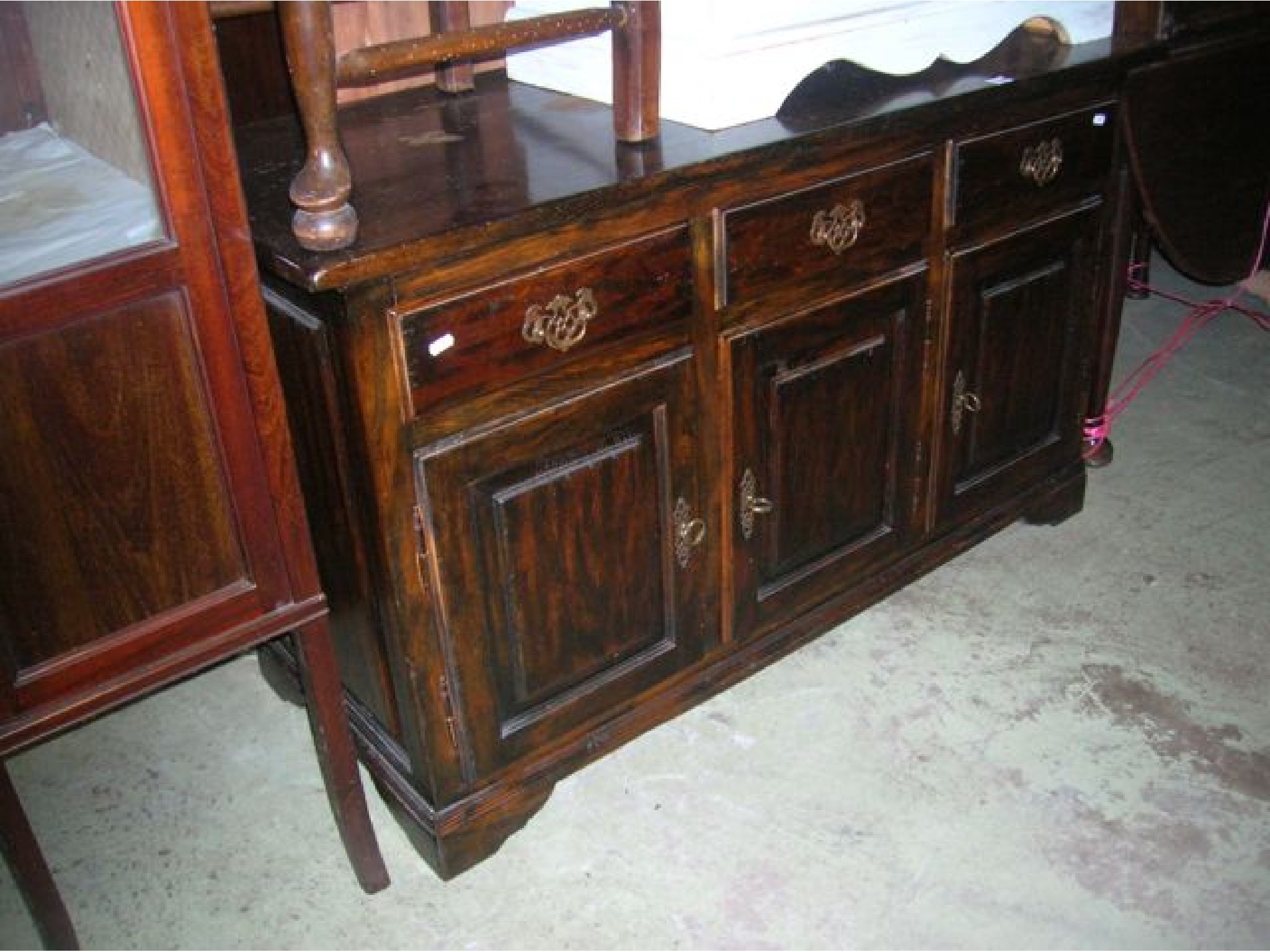 Appraisal: A reproduction oak dresser base enclosed by three rectangular fielded