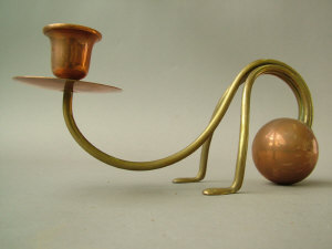 Appraisal: An arts and crafts style copper and brass candlestick on